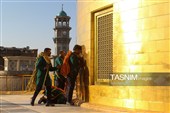آیین تعویض پرچم گنبد حرم مطهر رضوی